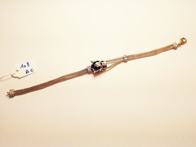 a silver bracelet with a black bead on it