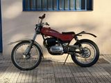 a motorcycle parked in front of a building next to a window