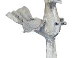 a statue of a bird that is holding a piece of paper