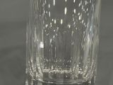 a glass of water sitting on a table with a black background