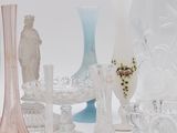 many different glass vases and vases on the table