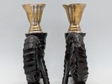 pair of black and gold vases with a woman ' s head on them
