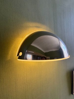 an image of a wall mounted lamp on a green wall