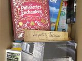 many books in a box that are sitting on a table