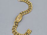 a close up of a gold chain bracelet with a clasp