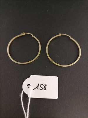 two gold hoop earrings with a price tag on a black background