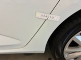 a sticker on the side of a white car