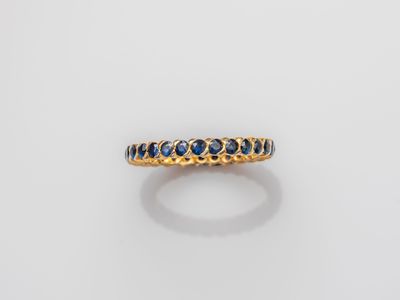 a yellow gold ring with blue sapphires