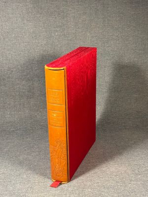 an orange and yellow book sitting on top of a gray surface
