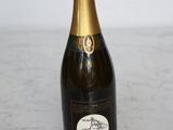 a bottle of champagne sitting on a marble table