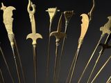 an image of a gold sculpture of a bunch of knives