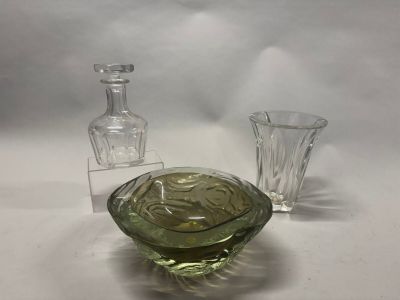 un saladier en verre et une bouteille en verre posés sur une table