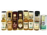 many different types of bottles of alcohol on a white surface