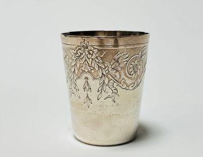 a silver cup with a floral design on it
