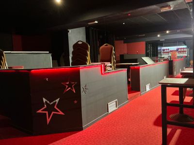 a red carpeted room with a bar and a red carpet
