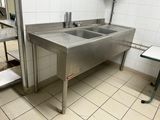 a stainless steel sink in the middle of a kitchen