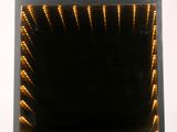 a picture of a square mirror with lights in it