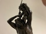a statue of a man holding a baby on his back