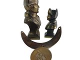 two bronze statues of a man and a woman on a crescent