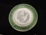 a green plate with a picture of a man riding a horse on it