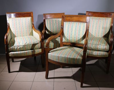 two wooden chairs with striped upholstered upholstered cushions