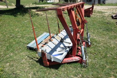a red crane that is sitting in the grass