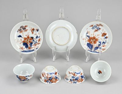 a group of porcelain dishes and cups sitting on a table