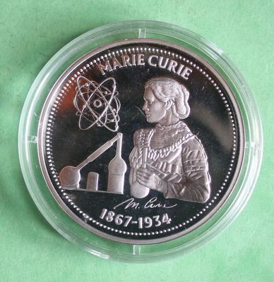 a close up of a coin in a plastic container on a green surface