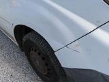 a close up of a white car with a flat tire
