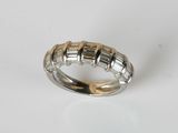 a close up of a silver and gold ring on a white surface