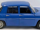a blue toy car that is sitting on a white surface