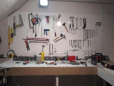 a workbench with many tools on it in a garage