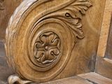 a wooden bench with carvings on the back of it