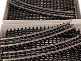 a lot of train tracks in a box on the table