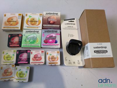 a box of waterdrops next to a bunch of other items