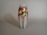 a vase with a design on it sitting on a table
