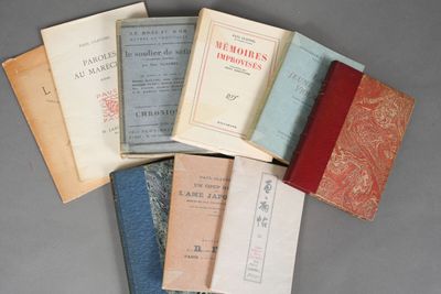 several old books are stacked on top of each other on a table