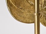 a close up of a gold leaf on a metal pole