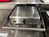 stainless steel counter top with an electric pizza oven on it