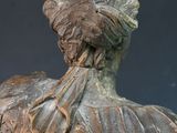 a statue of a woman with a bird on her shoulder