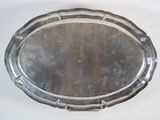 a silver tray on a white table with a white background