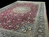 an image of a large red rug with a floral design on it