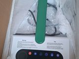 a white box with a green and black device in it