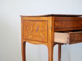 a small wooden table with a drawer on it