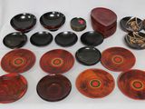 many plates and bowls that are on a table