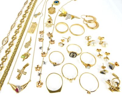 a lot of gold jewelry on a white surface