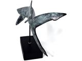 statue of a bird on a black stand on a white background