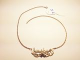 gold plated necklace with a chain and a bird charm