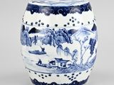 a blue and white vase with a landscape on it