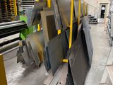 several pieces of metal are stacked up in a warehouse